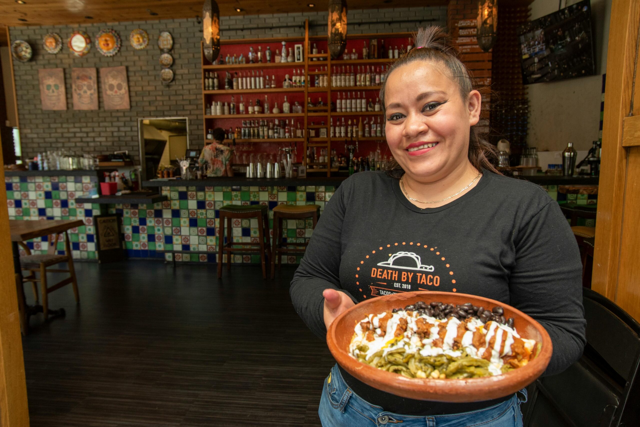 Woman with a traditional Mexican dish at a San Francisco restaurant.